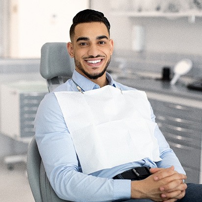 Patient smiling while sitting in treatment chair