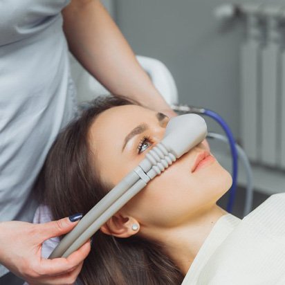 Lady is fitted with face mask for nitrous oxide