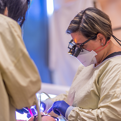 Dentist and assistant performing a dental procedure on a patient