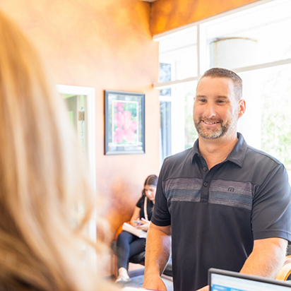 Man checking in at front desk of dental office in Morgan Hill