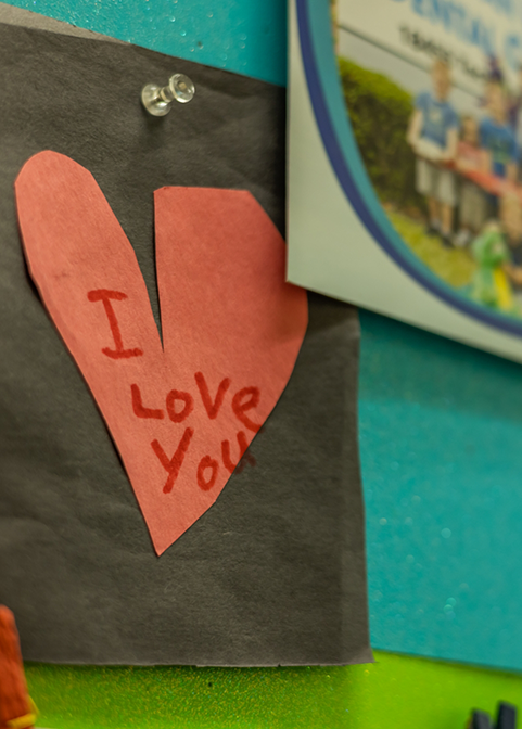 Paper cut out of a red heart with the words I love you written on it