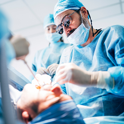 Dentist and assistants performing a dental procedure on a patient