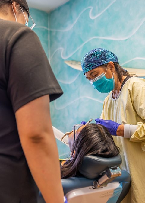 Dentist and assistant performing a procedure on a patient with dental implants in Morgan Hill