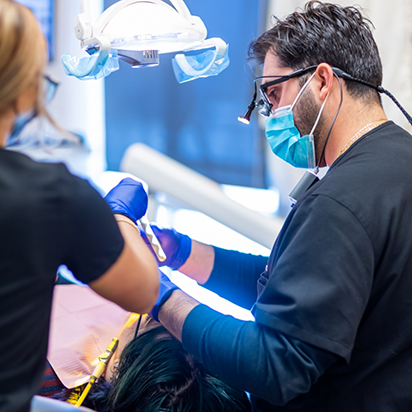 Dentist and assistant treating a patient