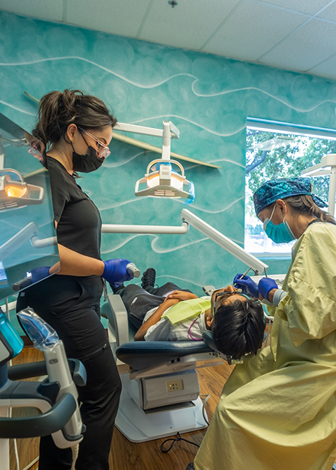 Dentist and assistant performing a dental procedure on a patient