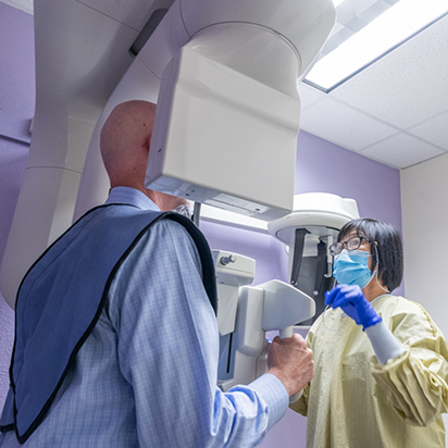 Dental patient receiving a C T cone beam scan of his mouth and jaw