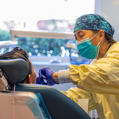 Dentist performing gum disease treatment on a patient