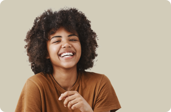 Young person in dark orange shirt laughing