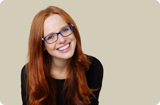 Redheaded woman with glasses smiling