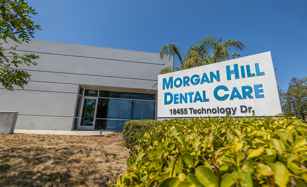 Sign outside of dental office in Morgan Hill that reads Morgan Hill Dental Care 18455 Technology Drive