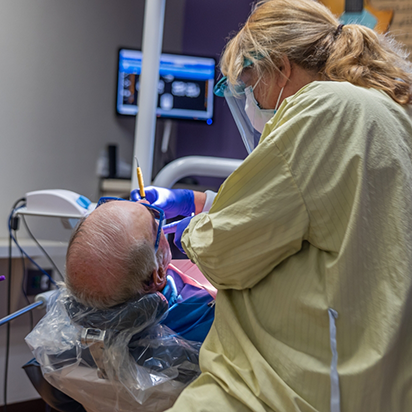 Oral surgeon performing a procedure on a patient