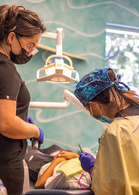 Dentist and assistant providing dental services in Morgan Hill to a patient