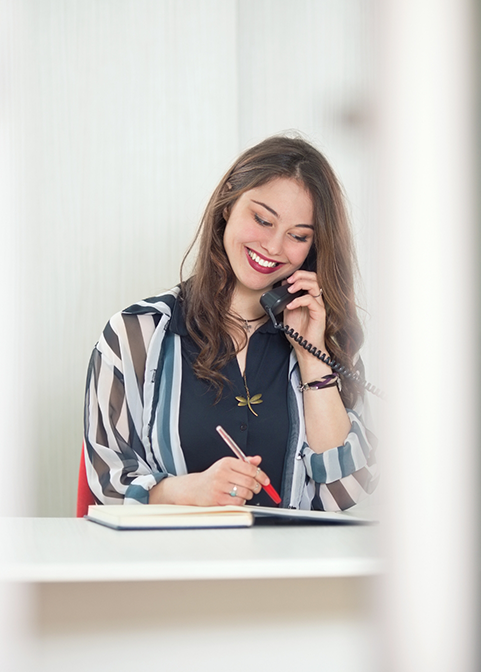 Woman smiling while talking on the phone