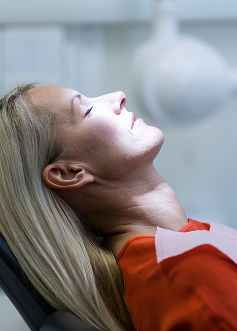 Woman relaxing in the dental chair thanks to sedation dentistry in Morgan Hill