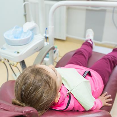 Young girl leaning back in the dental chair