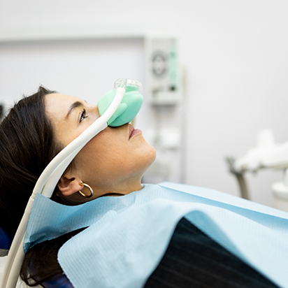 Dental patient with nitrous oxide mask over her nose